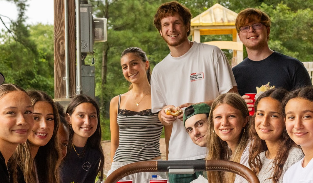 Students gathered outside for food and fellowship at a student ministry cookout
