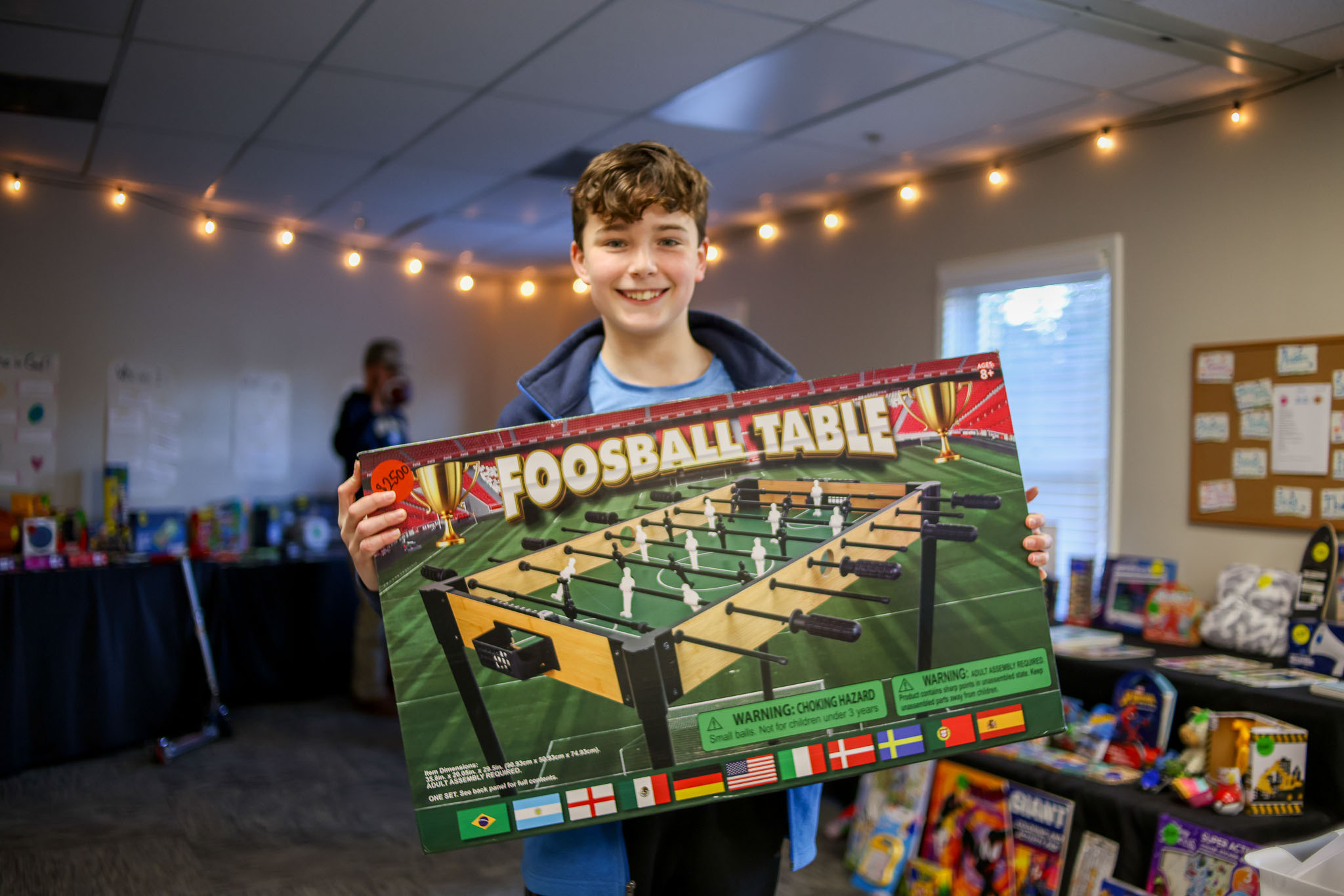 A child celebrating a prize earned at the Navigators Trading Post